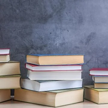Stacks of books several on a gray background close-up. Back to school, educat Stock Photos