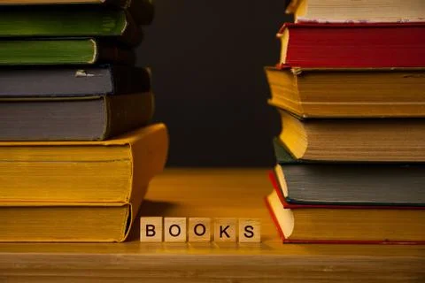 Stacks of books on a table in a library Stock Photos