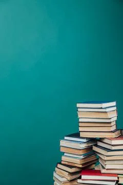Stacks of books for teaching knowledge college library green background Stock Photos