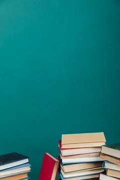 Stacks of books for teaching knowledge college library green background Stock Photos