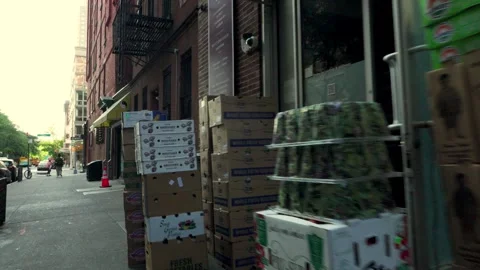 Stacks of boxes containing fresh produce being delivered to an upper east si Stock Footage 242310500