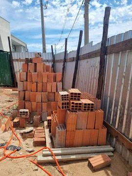 Stacks of bricks and tile siding under construction Foto stock