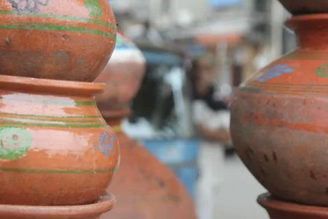 Stacks of brown ceramic pot next to stack of ceramic pot Stock Photos