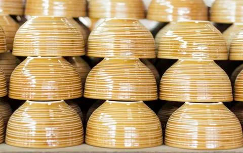 Stacks of brown cups in warehouse Stock Photos