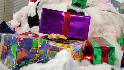 Stacks of Christmas gift boxes downstairs in beautiful twinkling lights Stock Footage 261023086