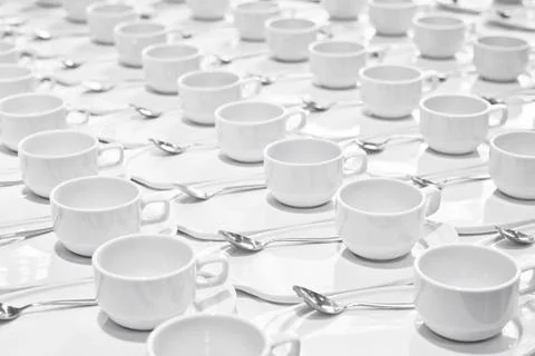 Stacks of coffee cups  with silver teaspoons  prepare for meeting Stock Photos