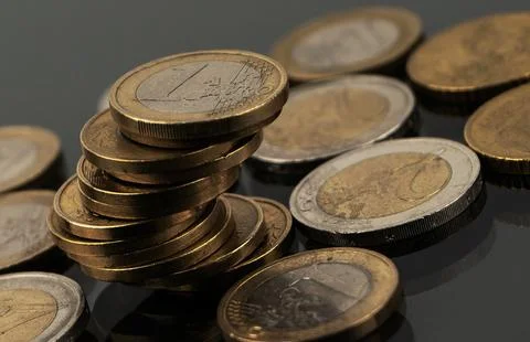 Stacks of coins on a black background 스톡 사진