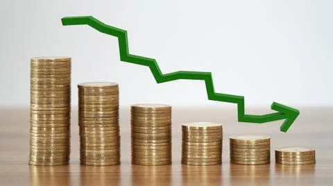 Stacks of coins in a decrease financial concept. Stock Photos