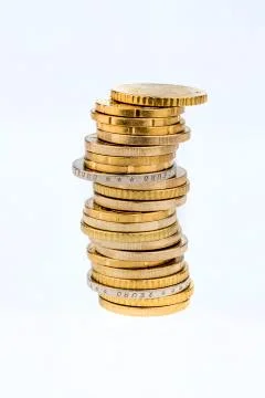 Stacks of coins in front a white background 스톡 사진