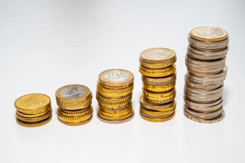 Stacks of coins of increasing height. Stock Photos