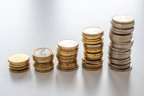 Stacks of coins of increasing height. Stock Photos