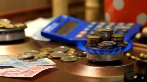 Stacks of coins stand in the flame of a lit gas burner Stock Footage 100392058