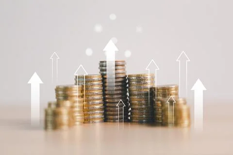 Stacks of coins with upward arrows representing financial growth, investmen.. Stock Photos
