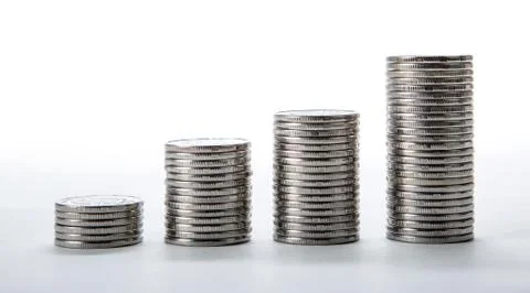 Stacks of coins on a white background Stock Photos