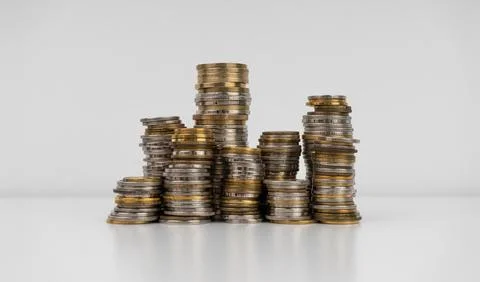 Stacks of coins on a white background Stock Photos