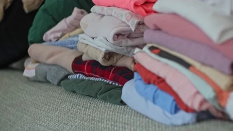 Stacks of Colorful Folded Laundry Second Hand Clothes Prepared for Bulk Sale Stock Footage 232544341