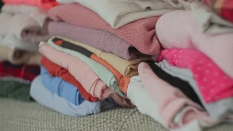 Stacks of Colorful Folded Laundry Second Hand Clothes Prepared for Online Sale Stock Footage 232544540