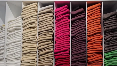Stacks of colorful socks organized in white storage compartments. Retail display Video stock 300299524