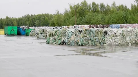 Stacks of compact plastic garbage and other trash stored for recycling in Video stock 170678063