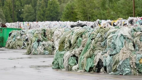 Stacks of compact plastic garbage stored for recycling in landfill near Video stock 170678361
