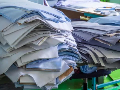 Stacks of Cut Fabric Patterns in Garment Factory Stock Photos