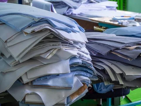 Stacks of Cut Fabric Patterns in Textile Factory Workshop Stock Photos