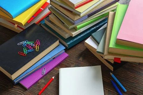 Stacks of different books on dark rustic table. Copy space Stock Photos