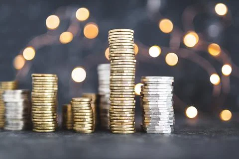 Stacks of different golden and silver coins creating a big amount of savings  Stock Photos