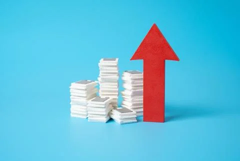 Stacks of documents and a red arrow pointing up. Increased bureaucracy, more  Stock Photos