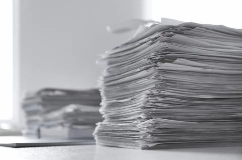 Stacks of documents on desk in office Stock Photos
