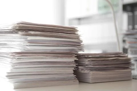 Stacks of documents on desk in office Stock Photos