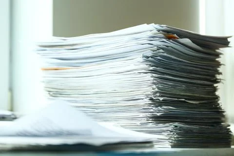 Stacks of documents on desk in office Stock Photos