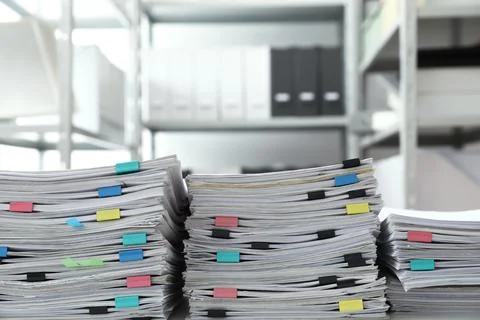 Stacks of documents with paper clips in office Stock Photos