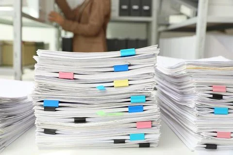 Stacks of documents with paper clips on office desk Stock Photos