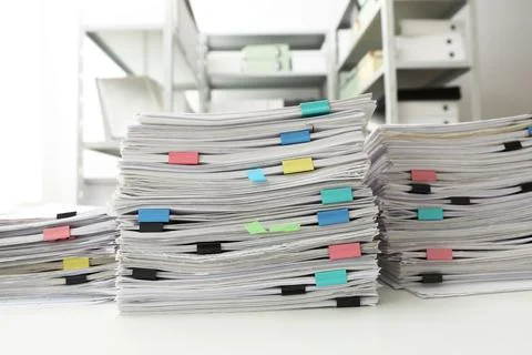 Stacks of documents with paper clips on office desk Stock Photos