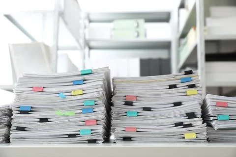Stacks of documents with paper clips on office desk Stock Photos