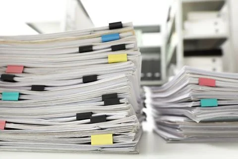 Stacks of documents with paper clips on office desk, closeup Stock Photos