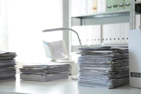 Stacks of documents on table in office Stock Photos