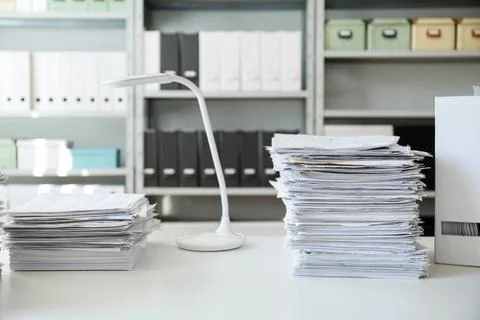 Stacks of documents on table in office Stock Photos