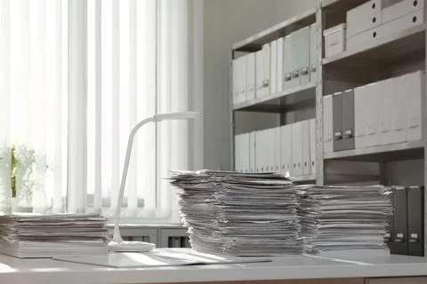 Stacks of documents on table in office Stock Photos