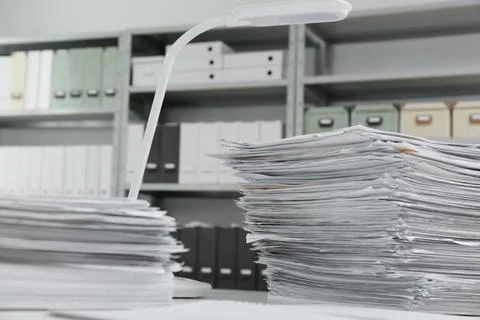Stacks of documents on table in office Stock Photos