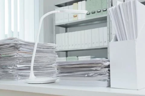Stacks of documents on table in office Stock Photos