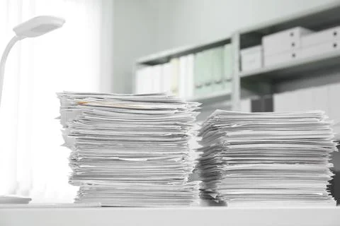 Stacks of documents on table in office Stock Photos