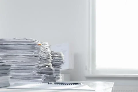 Stacks of documents on table in office. Space for text Stock Photos