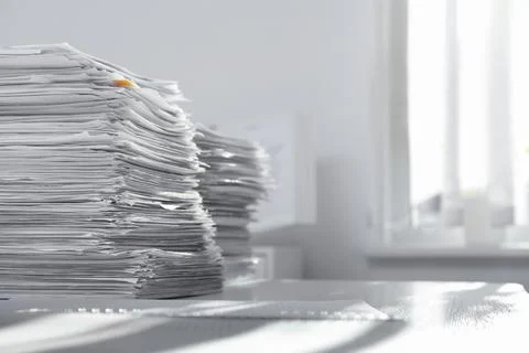 Stacks of documents on table in office. Space for text Stock Photos