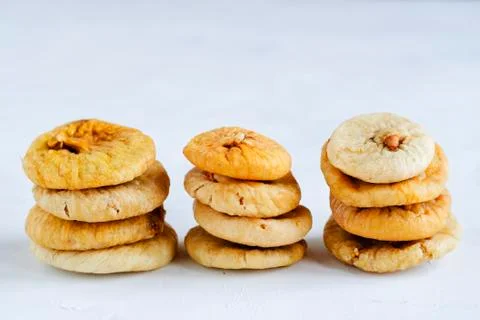 Stacks of dried figs on white backdrop Stock Photos
