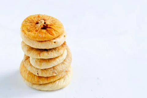 Stacks of dried figs on white backdrop Foto stock