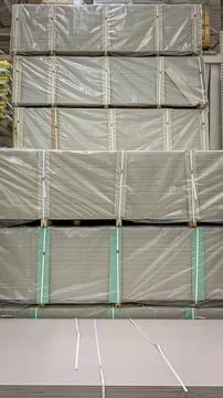 Stacks of drywall packages packed in polyethylene Stock Photos