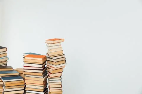 Stacks of educational books for teaching in the library on a white background Stock Photos