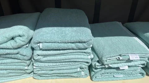 Stacks of Folded Aqua Bath Towels on Outdoor Resort Shelf Stock Footage 345369810